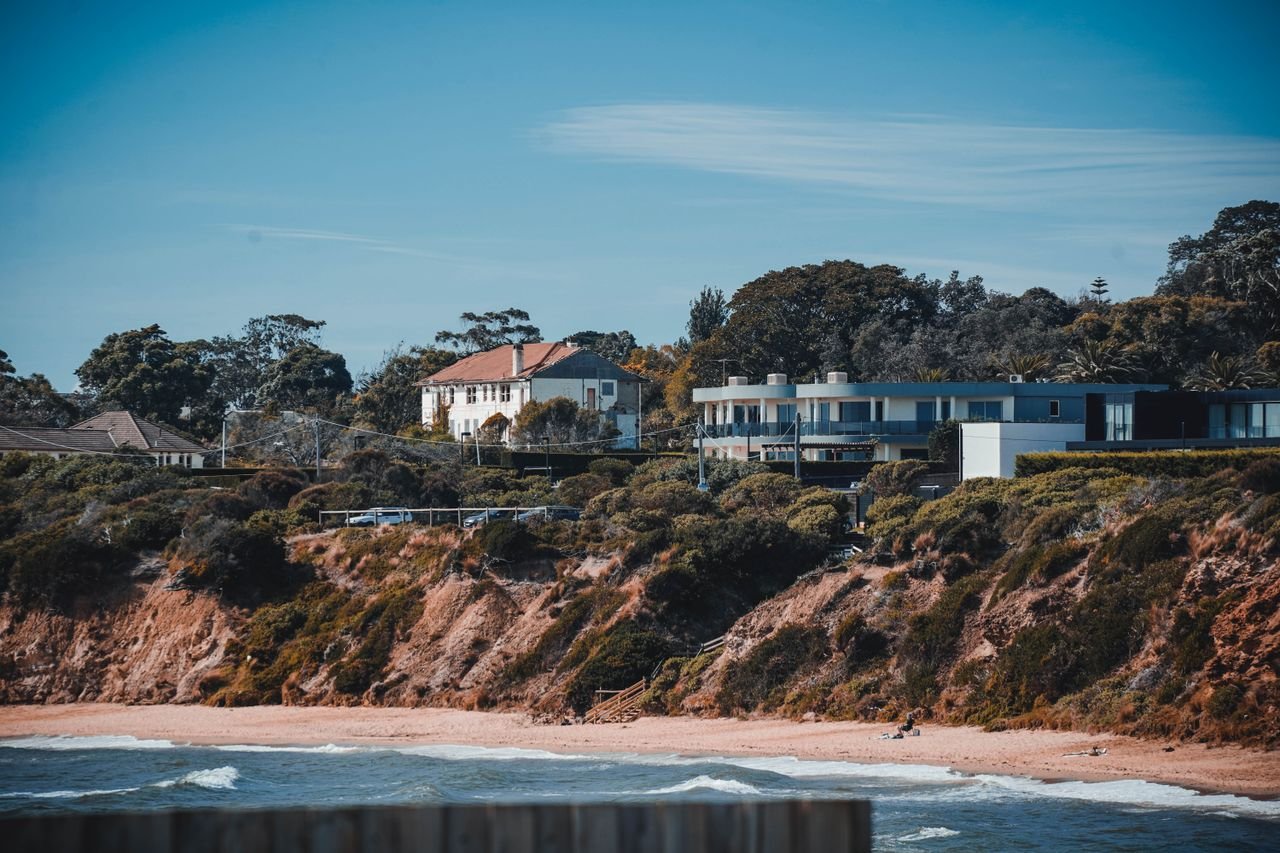 A picturesque view of coastal houses atop a scenic beach, exuding tranquility.